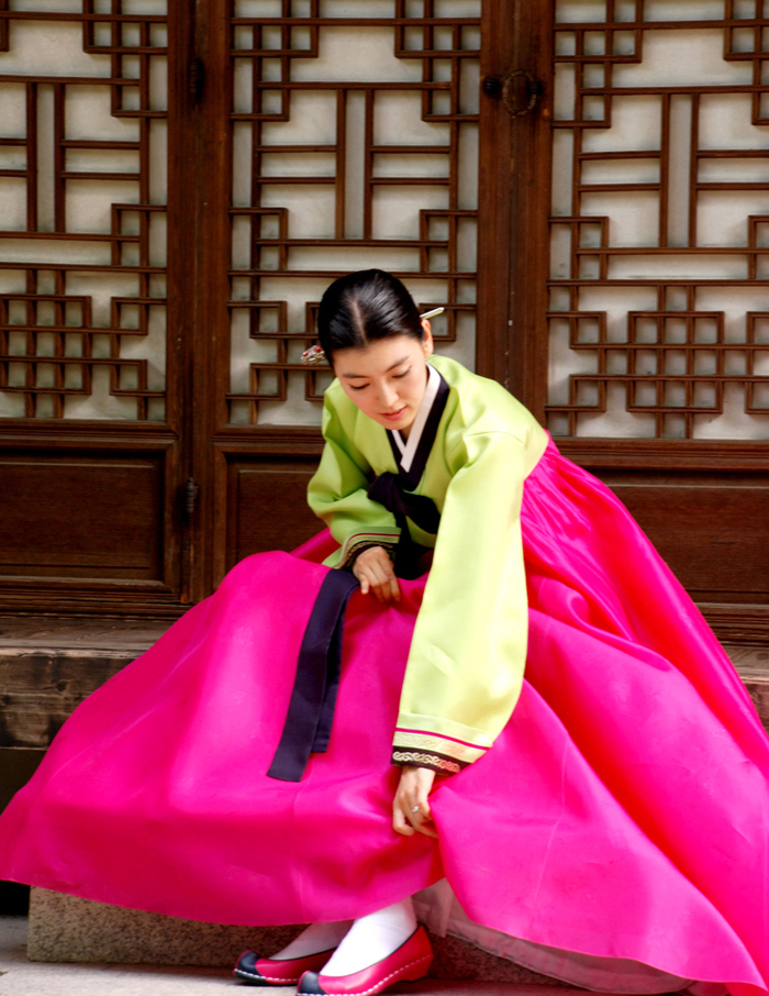 Woman wearing hanbok and flower shoes