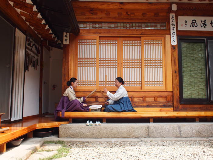 Mother and daughter-in-law ironing Korean traditional way